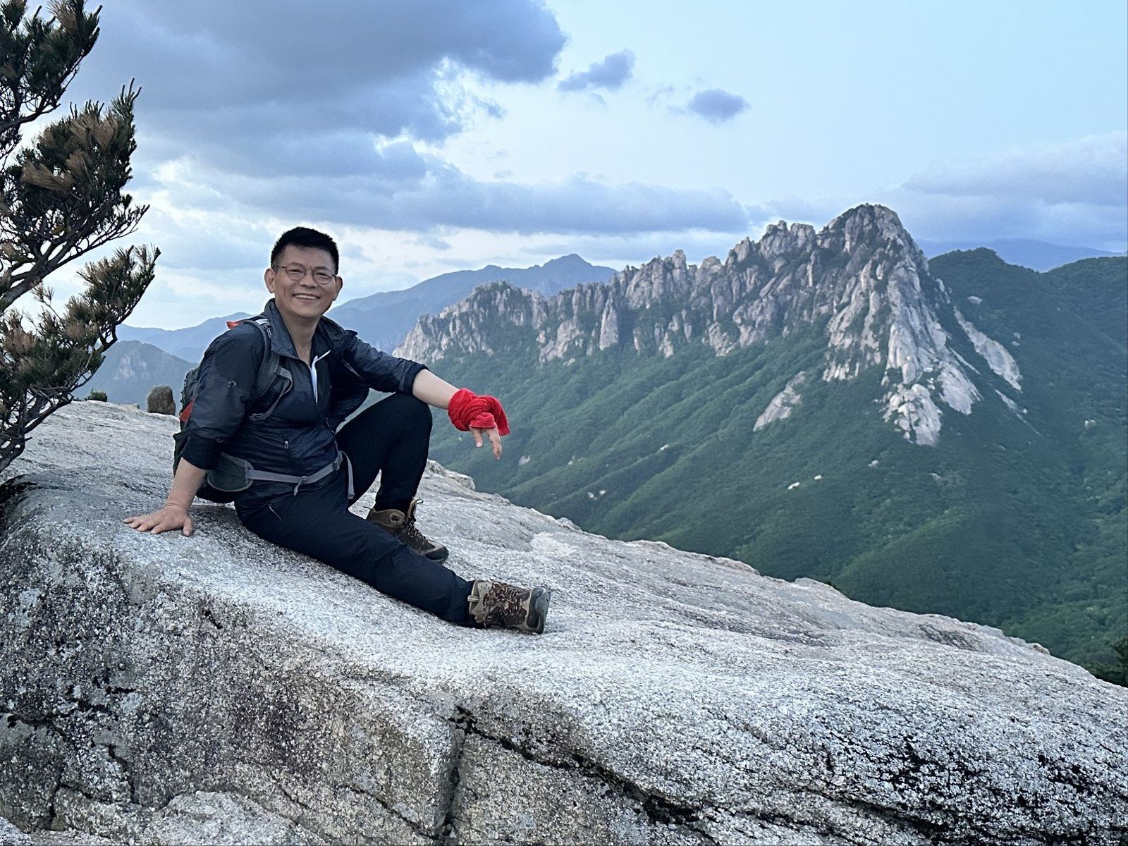 The guide resting on a granite ledge below Ulsanbawi, Seoraksan